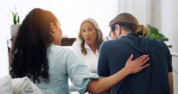 istock Therapy, couple and people with support for counseling, relationship and help in office. Psychologist, talking and woman comfort man for healing, consultation and marriage reconciliation with care 2234616566