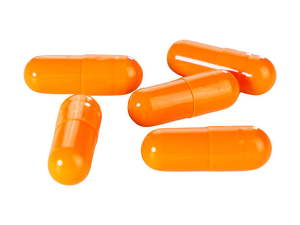 istock Bulk orange capsule pills isolated on white background. 2234617132