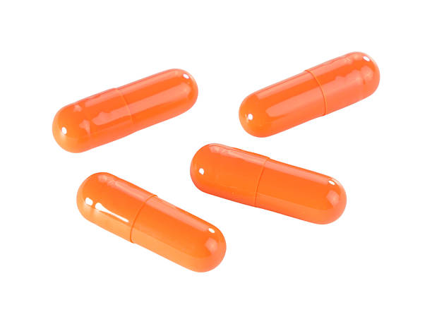 istock Bulk orange capsule pills isolated on white background. 2234617145