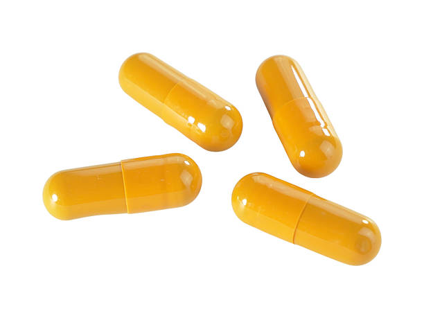 istock Bulk orange capsule pills isolated on white background. 2234617159