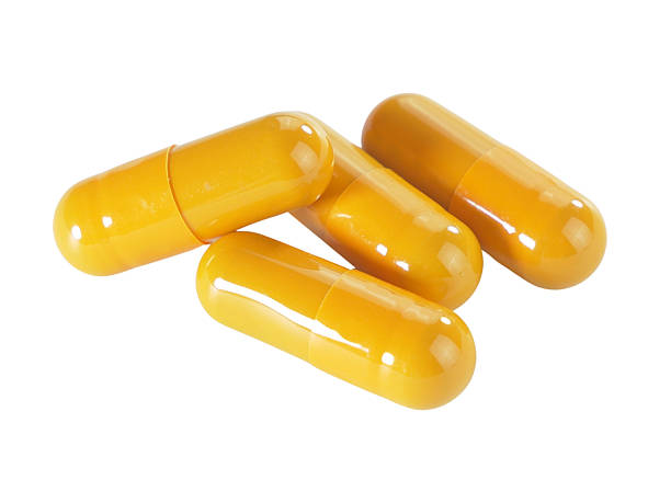 istock Bulk orange capsule pills isolated on white background. 2234617165