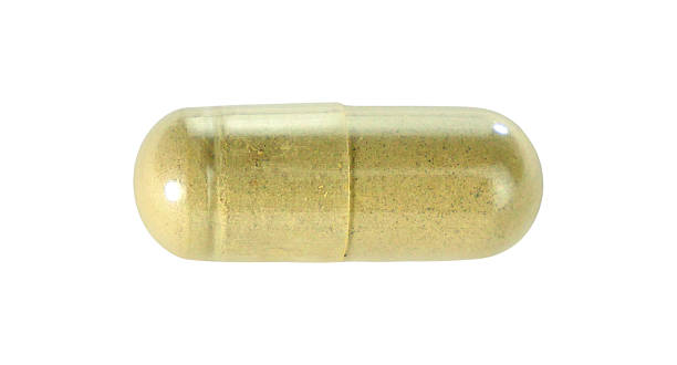 istock One green herbal capsule pills isolated on white background. 2234617200