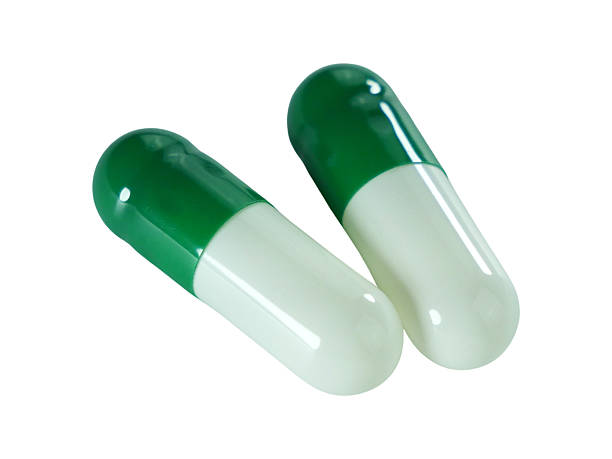 istock Bulk green and white capsule pills isolated on white background. 2234617227