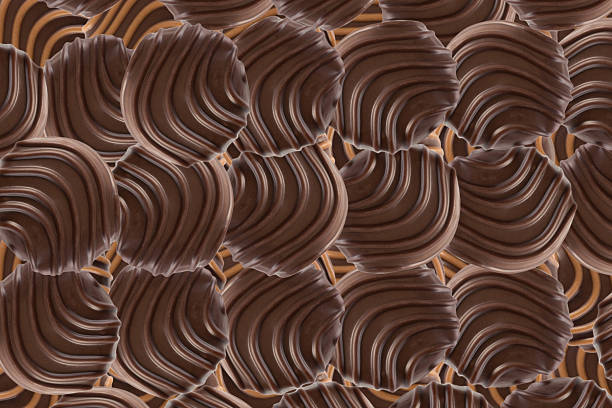 Top view of round milk chocolate pralines arranged in a regular pattern on dark background. Sweet candy layout with shadowed bonbons