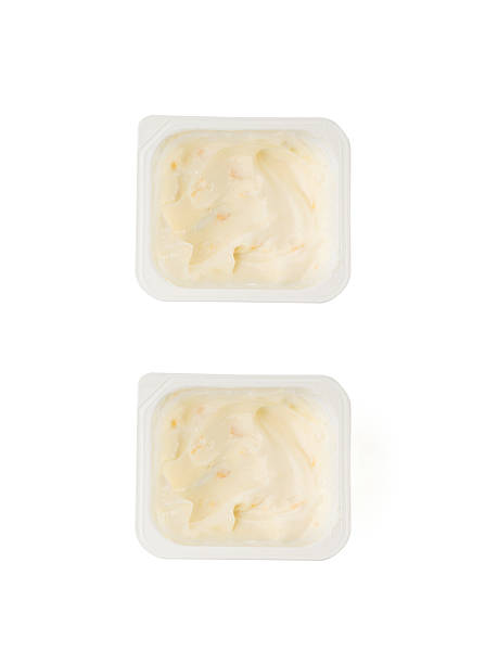 istock Yogurt cup isolated, yoghurt with orange fruits pieces in plastic pot, milk pudding container 2234618249