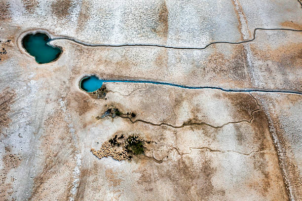 istock NATURAL GROUNDWATER SOURCECracked dry soil and shrinking lakes. PATTERNS emerging in nature, abstract shapes, drought and climate crisis, water scarcity, global warming, and drying soils.DRONE photo 2234619481