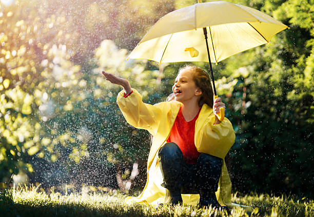Happy child girl with an umbrella on autumn walk