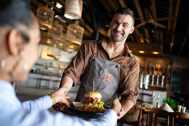 istock Restaurant marketing moment, a fresh burger and fries served with a smile creates visual content 2234619829
