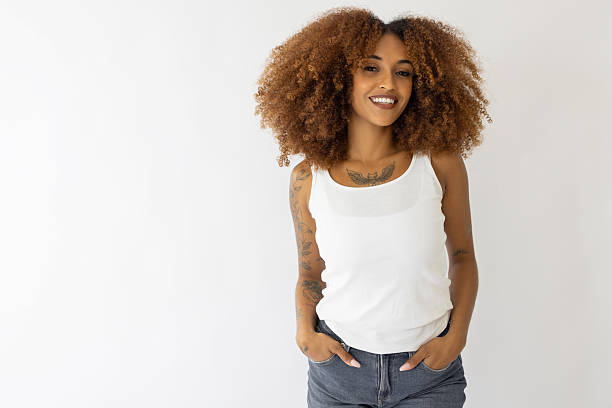istock Female with afro hair and tattoos smiling through camera 2234624924