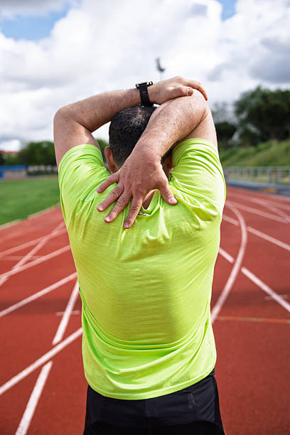 istock Mature male athlete stretching on running track 2234626051
