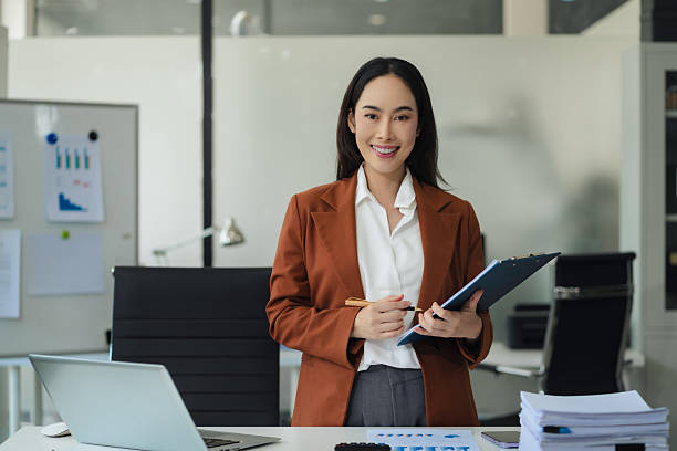 istock Woman successful standing front at the desk, looking to camera. 2234628714