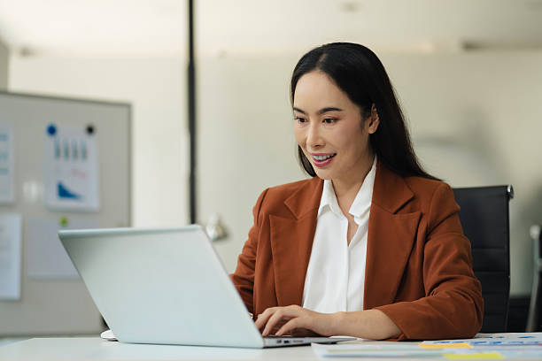 istock Businesswomen hand working with tablet and laptop computer with documents on office desk in modern office. 2234628726