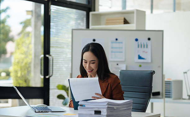 istock Businesswomen hand working with tablet and laptop computer with documents on office desk in modern office. 2234628740