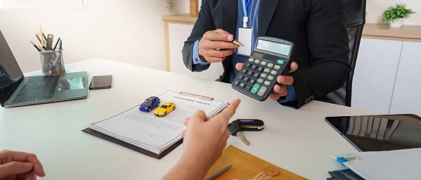 istock Car Dealership. Discussing vehicle financing options with a client. 2234630124