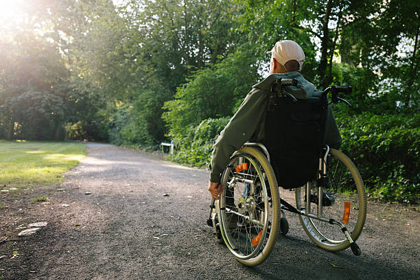 Schoolgirl running towards an elderly man in a wheelchair isolated on white background