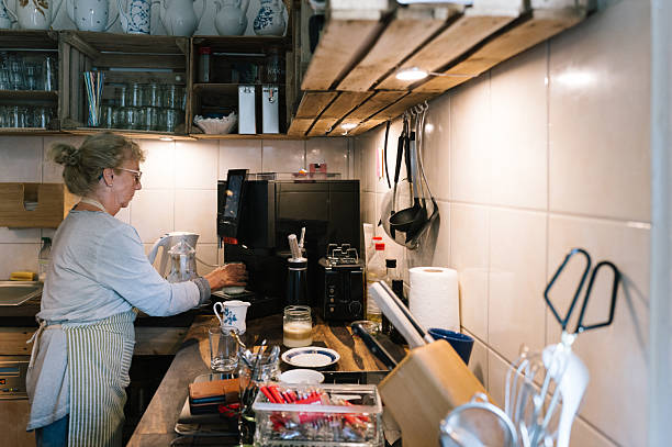 istock waitress is preparing hot drinks at a vending machine in a retro kitchen 2234632406