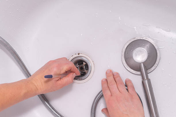 istock Simple home maintenance task of clearing drain to improve plumbing function and hygiene. 2234632754