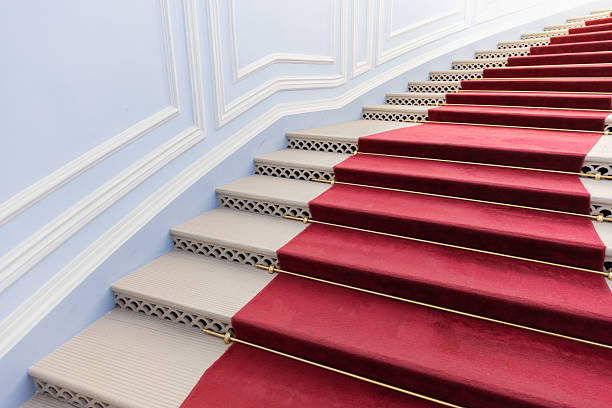 Looking down on a staircase with red carpet