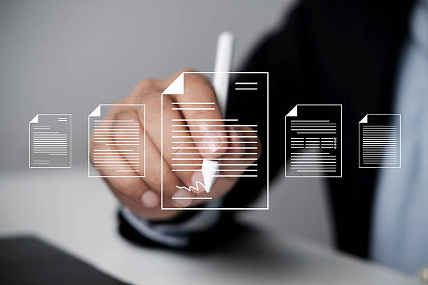 istock Businessman uses digital pen to sign virtual digital contact. E-signing on an e-document, 2234635622
