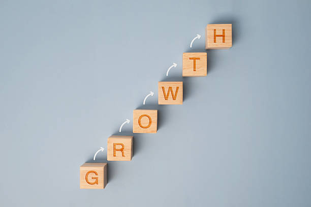 istock Wooden block stacking as step stair on blue background. Growth process with arrows on wooden blocks. Business growth success achievement concept. 2234635676