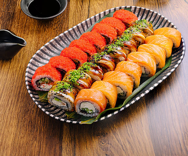 istock Colorful sushi platter served on a wooden table at a dining space 2234637017