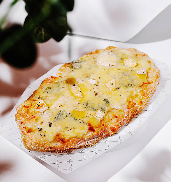 istock Delicious freshly baked flatbread topped with cheese and vegetables 2234637466
