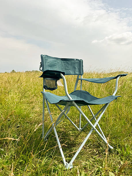 istock Folding chair in a green field 2234637559