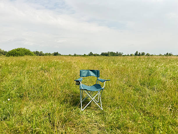 istock Folding chair in a green field 2234637674