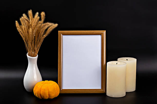 istock Autumn themed mock up with empty frame, candles, decorative pumpkin, and dried flowers 2234639245