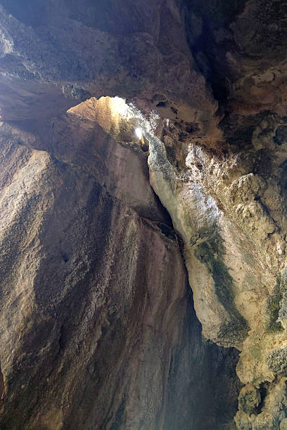 istock Majestic limestone cave interior with light filtering through high ceiling 2234639345
