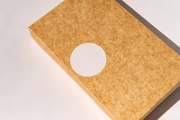 istock Brown textured cardboard box with circular white label on surface 2234639475