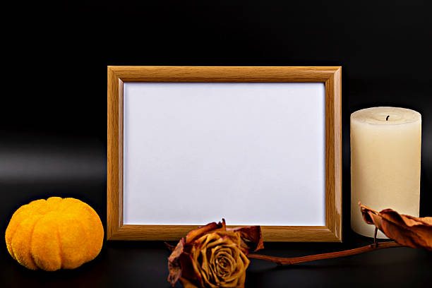 istock Empty wooden frame with copy space, surrounded by autumn leaves, pumpkin and candle for Halloween theme 2234639751