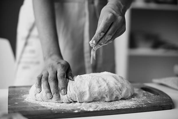 istock Unknown Man Kneading Dough and Sprinkling Flour on Table 2234640689
