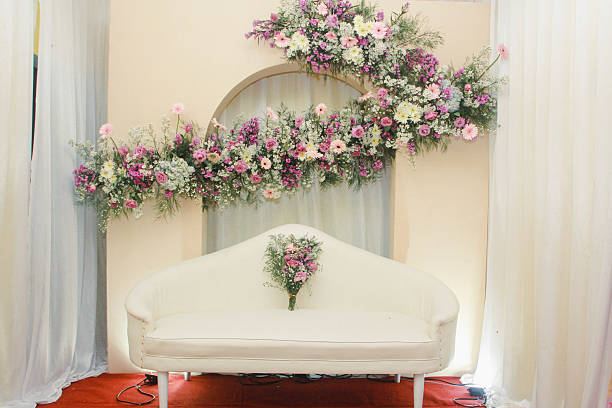 istock Elegant Bridal Ceremony Setup With Sofa and Floral Arch Backdrop 2234642534