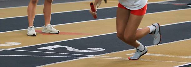 Runner Prepares for Baton Exchange During a Relay Race