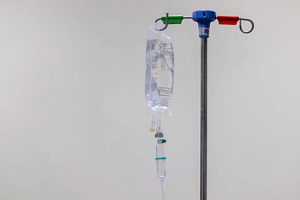 istock An IV or intravenous fluid bag hanging on poles with white background 2234643224