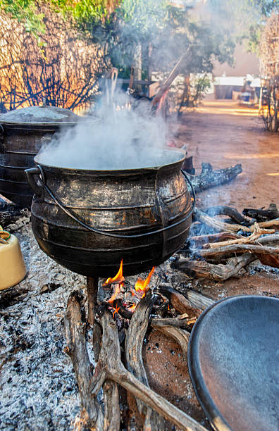 istock african traditional cooking outdoors in the open fire kitchen on cauldron three legged pot, boiling meat stew 2234643590