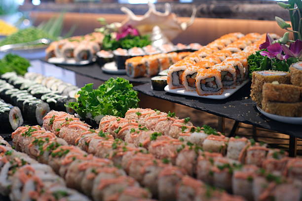 istock Fried sushi rolls topped with creamy filling, spoon adding garnish, crispy crust, vibrant colors, professional presentation, food preparation closeup 2234643897