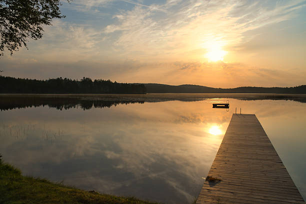 istock Romantic jetty on the lake at sunset with calm water 2234648063