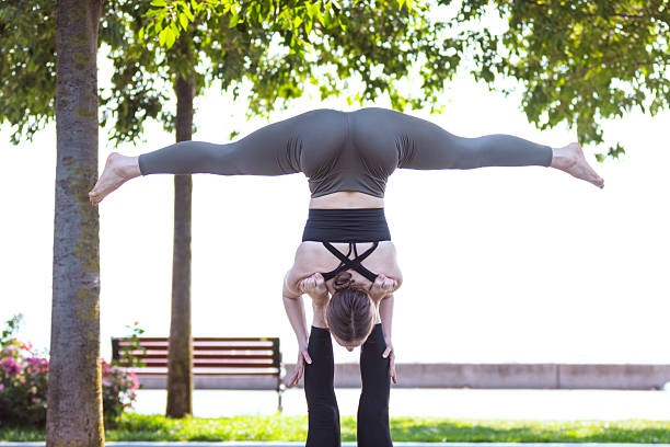 Young woman is exercising at public park with her friend.
