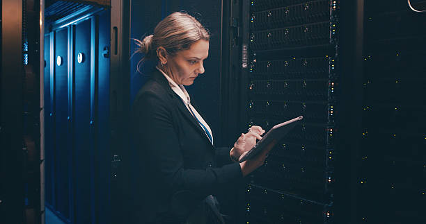 istock Engineer, woman and typing on tablet in server room for cybersecurity, system backup or update. Data center, serious person or digital app for network configuration, technical solution or maintenance 2234648722