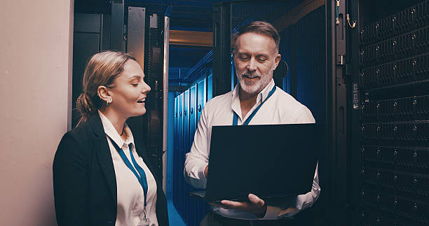 istock Collaboration, cybersecurity and laptop with people in server room together for network administration. Computer, storage and upgrade with tech support team in data center for firewall installation 2234648724