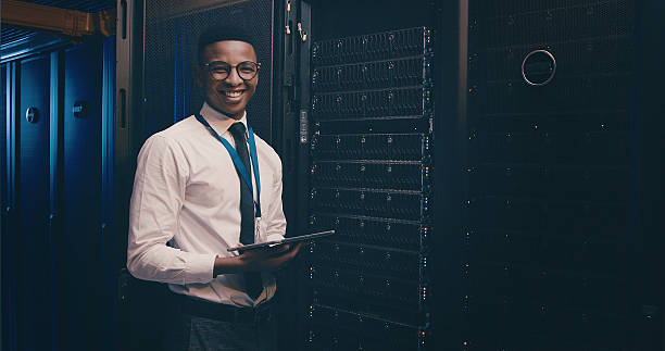istock Engineer, black man and portrait with tablet in server room for inspection, system update or happy. Data center, technician and space for network configuration, technical solution and troubleshooting 2234648745