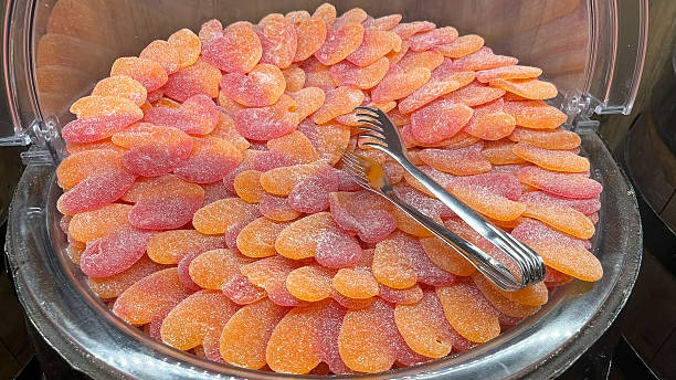Soft, orange and pink jelly beans shaped like peaches and covered in sugar.