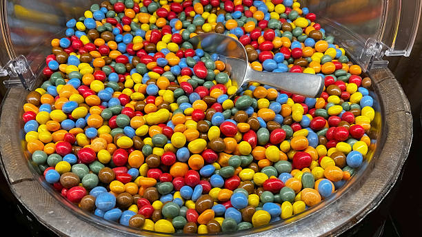 Chocolate-covered chickpeas and pistachio candies in different colors.