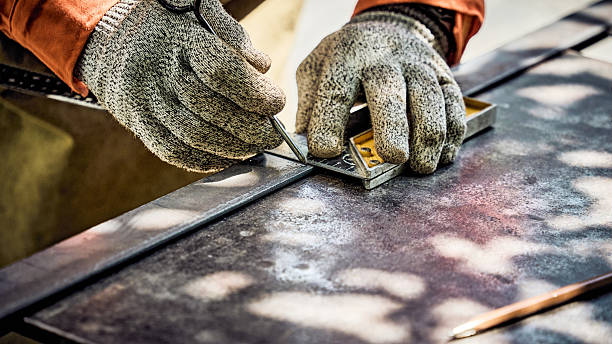 istock A worker in protective gloves is marking a part with a square 2234652360
