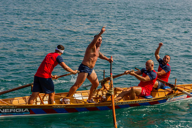 Sailing team pulling rope on yacht