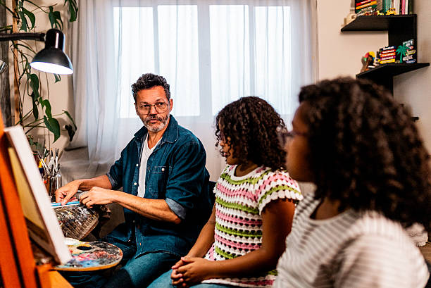 istock Father teaching his daughters how to paint at home 2234656571