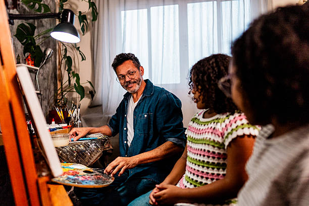 istock Father teaching his daughters how to paint at home 2234656586