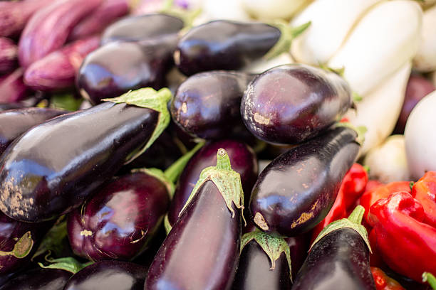 istock Fresh eggplants and peppers displayed at a farmers market 2234657792